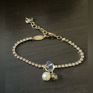 Vintage gold tone Sabika bracelet with pale pinkish purple rhinestones.